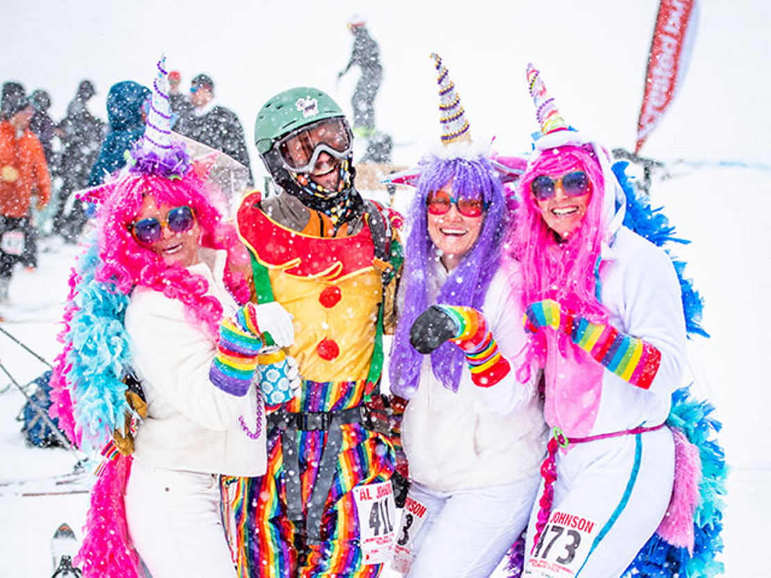 Costumed race competitors pose together for a photo.